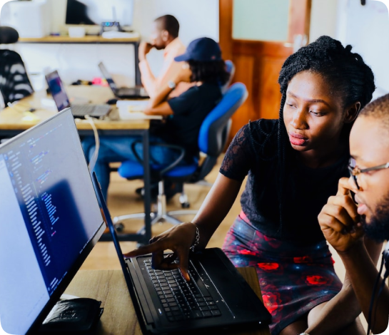 man and woman analyzing data on a computer