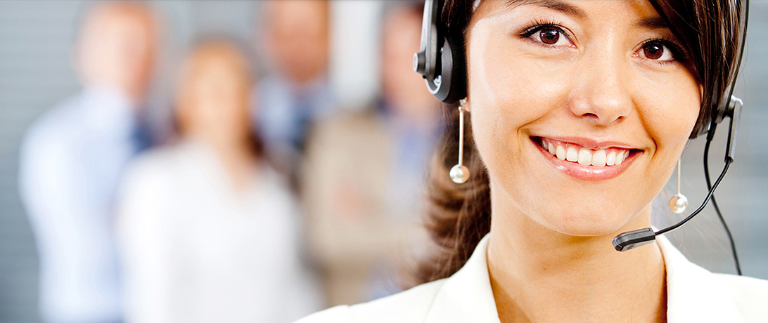 women working a in hotline center and smiling